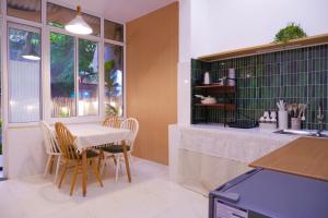 a kitchen with a table and chairs in a kitchen at Ni Nớ Home in Hue