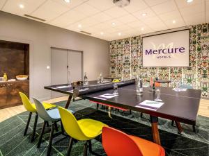 a meeting room with a long table and chairs at Mercure Cavaillon in Cavaillon +198 photos