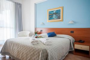 Postel nebo postele na pokoji v ubytování Hotel Bacco