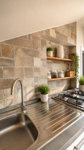 a kitchen with a sink and a stove at mansarda roulette in Saint Vincent