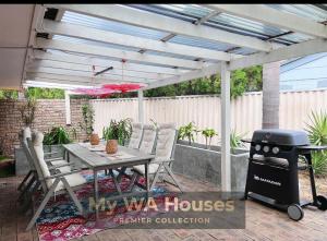 a patio with a grill and a table and chairs at Edgewater Whole Holiday Resort in Perth +56 photos
