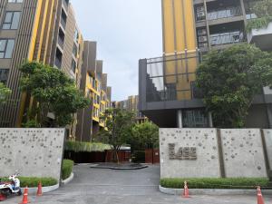 a parking lot in a city with tall buildings at The Base Central Phuket-a modern comfort condo-sso in Ban Rangeng