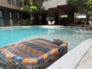 a swimming pool in the middle of a building at The Base Central Phuket-a modern comfort condo-sso in Ban Rangeng +11 photos