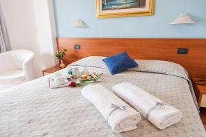Postel nebo postele na pokoji v ubytování Hotel Bacco