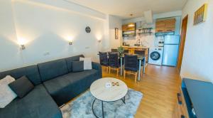 a living room with a couch and a table at DalEro Sunset Apartments Medjugorje in Međugorje