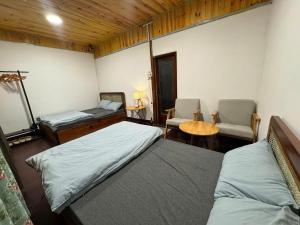 a bedroom with two beds and a table and chairs at Mây inn' Cầu Đất - Homestay in Xuân Trường +16 photos