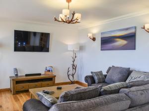 a living room with a couch and a table at Ryka Lodge in Back