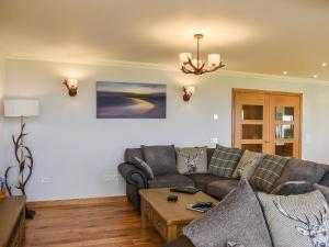 a living room with a couch and a table at Ryka Lodge in Back +29 photos