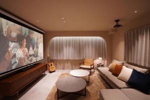 a living room with a large flat screen tv at TABISAI HOTEL Premium 博多-中洲 in Fukuoka