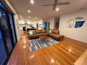 a living room with a couch and a table at Ballarat Suites in Ballarat