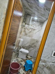 a bathroom with a toilet and a sink at krishna yadav homestay in Hospet