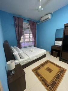 a blue room with a bed and a window at Deeja Homestay Kuantan in Kuantan +20 photos