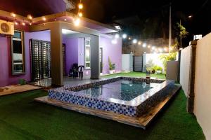 a swimming pool in the middle of a house at Deeja Homestay Kuantan in Kuantan