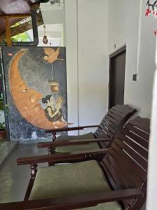 a room with two chairs and a painting on the wall at Cozy Sand Beach Hotel in Arugam Bay