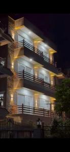 a large building with lights on it at night at Square Accommodation Rudra kunj in Pokhara