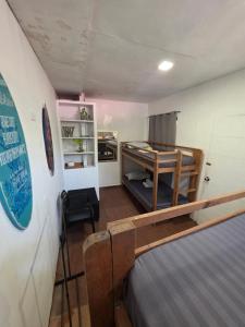 a small room with a bunk bed in a room at La Ud Lounge and Hostel in San Juan +21 photos