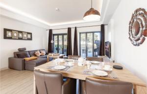 a dining room and living room with a table and chairs at Diamond in Binz