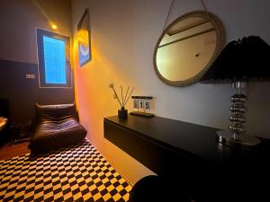a room with a mirror on the wall and a chair at Phố Homestay Phan Thiết in Phan Thiet +20 photos
