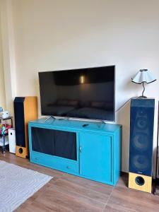 a blue entertainment center with a large flat screen tv at Phố Homestay Phan Thiết in Phan Thiet