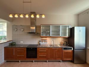 a kitchen with a sink and a refrigerator at Baltic Garden Villa in Gdynia +22 photos