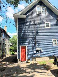a large blue house with a red door at Ana Maria del Azul in Minneapolis
