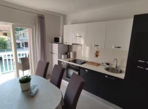a kitchen with a table and a sink and a table and chairs at Apartment Serenity in Rogotin