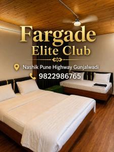 two beds in a hotel room with a sign that reads paragon elite club at Fargade Elite Club in Sangamner