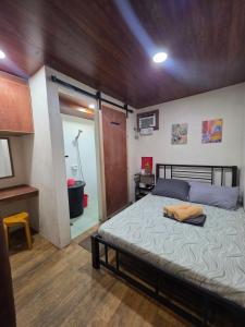 a bedroom with a large bed with a wooden ceiling at La Ud Lounge and Hostel in San Juan