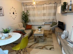 a living room with a couch and a table at A&M Burela Costa in Burela de Cabo +10 photos