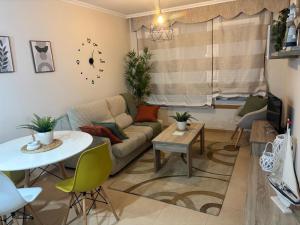 a living room with a couch and a table at A&M Burela Costa in Burela de Cabo