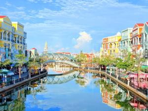 a river in a city with buildings and a bridge at StayLa Homestay Grand World Phu Quoc in Phú Quốc