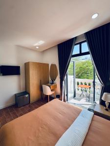 a bedroom with a large bed and a large window at StayLa Homestay Grand World Phu Quoc in Phú Quốc