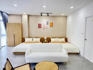 a bedroom with a large bed and a white couch at StayLa Homestay Grand World Phu Quoc in Phú Quốc +7 photos