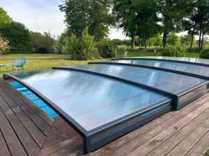 a large swimming pool on a wooden deck at La maison de Lilylou in Villars-Saint-Georges