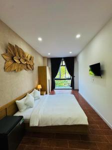 a bedroom with a large bed and a large window at StayLa Homestay Grand World Phu Quoc in Phú Quốc