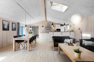 a living room and dining room with a table and chairs at FY134-Middelfart-Antaresvej-4 in Middelfart +18 photos