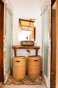 a bathroom with a sink and two baskets at Kelapa Lodge - Lombok - in Senggigi +25 photos