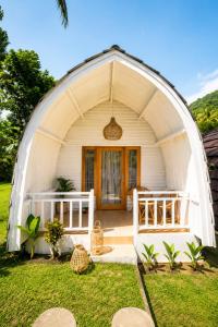 a white dome house with a door in the yard at Kelapa Lodge - Lombok - in Senggigi