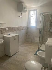 a bathroom with a shower and a toilet and a sink at Case vacanza Controvento in Palermo