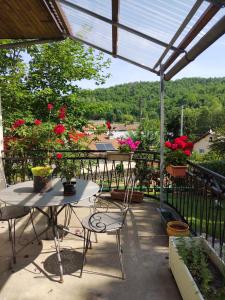 a balcony with a table and chairs and flowers at bibi in Cransac