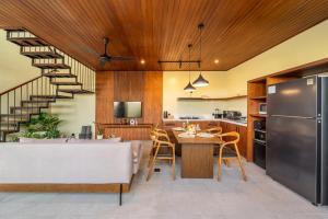 a kitchen and living room with a table and a refrigerator at Nala Villa - Peaceful Hideaway with Pool & Yoga Space in Canggu +30 photos