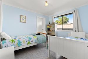 a bedroom with two beds and a window at Blue Meadow - Pet Friendly in Evans Head