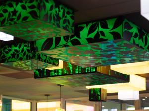 a group of stained glass lights hanging from the ceiling at ibis Styles Béziers Centre in Béziers