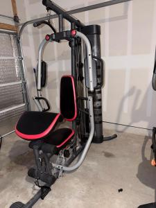 a gym with a red chair in a room at Cozy Retreat in San Antonio