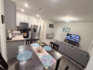 a kitchen and living room with a table and a couch at Cozy Retreat in San Antonio
