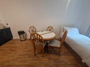 a bedroom with a table and chairs next to a bed at Spacious Bright Modern Apt With Garden in Dublin