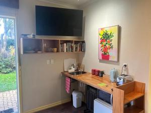 a small kitchen with a counter and a sink at Inner City Oasis in Invercargill