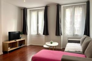 a living room with a couch and a tv at 35 min from Paris - Saint Maurice - Chez Nolan in Saint-Maurice