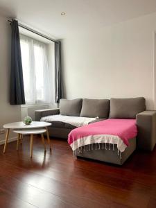 a living room with a couch and a table at 35 min from Paris - Saint Maurice - Chez Nolan in Saint-Maurice