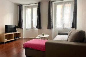 a living room with a couch and a tv at 35 min from Paris - Saint Maurice - Chez Nolan in Saint-Maurice